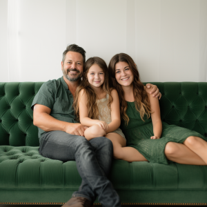 geee117_parents_sitting_on_a_green_couch_with_a_9_year_old_girl_1b5e730e-4121-47f4-bd05-cfbce9d2c32e